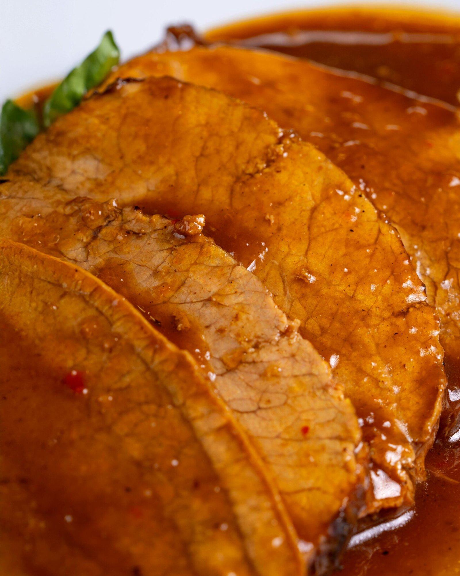 Deliciously tender slices of roast beef covered in savory brown gravy.